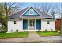Charming exterior featuring a white brick facade, blue accents, and a well-manicured lawn at 220 E Bell St # 7, Statesville, NC 28677