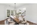 Elegant dining room with large windows and modern chandelier lighting at 7605 Berryfield Ct, Waxhaw, NC 28173