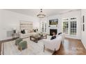 Bright living room with fireplace, large windows, and stylish furniture, perfect for relaxation and entertaining at 7605 Berryfield Ct, Waxhaw, NC 28173