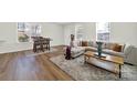 Spacious living area with stylish decor, plush seating, and beautiful hardwood flooring at 8004 Whitegrove Rd, Charlotte, NC 28227