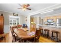 Warm dining area with hardwood floors, classic furniture, and an open kitchen view at 1912 Old West Ln, Gastonia, NC 28052