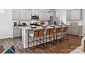 Modern kitchen featuring granite countertops, stainless steel appliances, and stylish bar stool seating at 1018 Mapletree Ln, Indian Trail, NC 28079