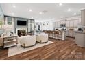 Open-concept living space with a fireplace, kitchen, dining area, and comfortable seating at 1018 Mapletree Ln, Indian Trail, NC 28079