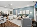 Bright and airy living room with hardwood floors, elegant furnishings, and ample natural light at 1018 Mapletree Ln, Indian Trail, NC 28079