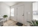 Bright entryway with hardwood floors and a large front door with glass peephole at 104 S Canyon Rdg, Mount Holly, NC 28120