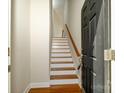Interior staircase with hardwood treads and a painted handrail, leading to upper level at 1122 Dean Hall Ln, Matthews, NC 28105