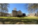 Spacious backyard featuring a deck, fenced-in area, and second building at 1134 Riverside Dr, Charlotte, NC 28214
