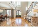 Grand foyer with hardwood floors, soaring ceilings, elegant staircase, and lots of natural light at 115 Stonewall Beach Ln, Mooresville, NC 28117