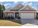 Charming single-story home with neutral siding, attached garage, well-kept lawn, and covered front porch at 116 Water Ski Dr, Statesville, NC 28677
