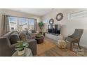 Bright living room featuring hardwood floors, modern furnishings, and plentiful natural light at 126 Johns Cardinal Dr, Mooresville, NC 28115