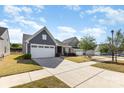 Beautiful, one-story home featuring a well-kept lawn and driveway, complemented by the blue sky at 1774 Slippery Rock Ln, Monroe, NC 28112