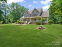 Charming two-story home with a stone facade, inviting front porch, and manicured lawn at 217 Blossom Hill Rd, Lincolnton, NC 28092