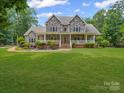 Charming two-story home with a stone facade, inviting front porch, and manicured lawn at 217 Blossom Hill Rd, Lincolnton, NC 28092