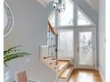 Welcoming entryway with stylish staircase, decorative mirror, and ample natural light from the large, modern windows at 22970 Lake Tillery Rd, Albemarle, NC 28001