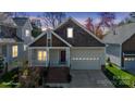 Charming home featuring a two-car garage and cozy front porch at 2620 Merion Hills Ct, Charlotte, NC 28269
