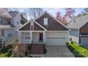 Charming home featuring a two-car garage and cozy front porch at 2620 Merion Hills Ct, Charlotte, NC 28269