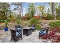 Landscaped backyard patio area with a fire pit and comfortable seating, perfect for outdoor entertaining at 27 Heritage Ct, Lake Wylie, SC 29710