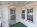 Close up of the white exterior front door with green carpeting on the porch, providing curb appeal at 28120 Ryan Rd, Richfield, NC 28137