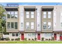 Charming townhome featuring a covered entry and lush landscaping, perfect curb appeal at 327 Uptown West Dr, Charlotte, NC 28208