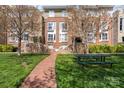 Multi-story brick building exterior with landscaped green space and walkway at 3939 Picasso Ct, Charlotte, NC 28205