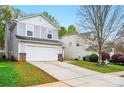Charming two-story home with a two-car garage, features a long driveway and well-maintained lawn at 4919 Manchineel Ln, Monroe, NC 28110