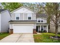 Charming two-story home with a two-car garage and stone accents, nestled in a lovely neighborhood at 4919 Manchineel Ln, Monroe, NC 28110