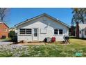 Cozy backyard with a door, a small patio, and views of beautiful little white flowers at 502 And 504 Church St, Belmont, NC 28012