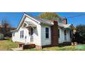 Charming home exterior with brick chimney, updated windows, and a covered side entry at 502 And 504 Church St, Belmont, NC 28012