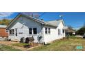 Well-maintained home exterior featuring white siding, updated windows, and a grilling area at 502 And 504 Church St, Belmont, NC 28012
