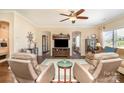 Cozy living room with plush seating, warm lighting, hardwood flooring and neutral paint, offering a comfortable space at 5115 Sand Trap Ct, Monroe, NC 28112