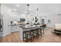 A modern kitchen features an island with bar stools, pendant lighting, and stainless steel appliances at 5248 Hatcher Creek Rd # 49, Charlotte, NC 28215