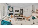 A contemporary living room with a cozy fireplace, sectional sofa, and stylish decor accents at 5248 Hatcher Creek Rd # 49, Charlotte, NC 28215