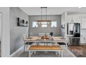 Elegant dining room with a rustic table, modern lighting, and stylish wall decor at 650 Scotch Meadows Loop, Monroe, NC 28110