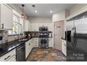 Kitchen featuring stainless steel appliances, white cabinets, and access to pantry at 6645 Allness Glen Ln, Charlotte, NC 28269