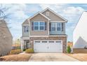 Inviting two-story home features a blend of siding and brick, complemented by a spacious driveway and attached garage at 684 Cape Fear St, Fort Mill, SC 29715