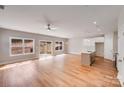 Open floor plan with kitchen island, stainless appliances, recessed lights, wood flooring, and sliding glass doors at 7444 Malabar Rd # 14, Huntersville, NC 28078