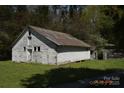 Rustic barn featuring a metal roof, offering ample storage space and potential for various uses at 7780 Stokes Ferry Rd, Salisbury, NC 28146