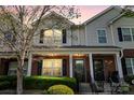 Attractive townhomes with brick and siding exteriors, complemented by black shutters and manicured shrubbery at 8453 Big Creek Ct, Charlotte, NC 28105