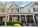 Attractive townhomes with brick and siding exteriors, complemented by black shutters and manicured shrubbery at 8453 Big Creek Ct, Charlotte, NC 28105