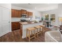 Modern kitchen featuring a breakfast bar, stainless steel appliances, granite countertops, and dark wood flooring at 1026 Mapletree Ln, Indian Trail, NC 28079