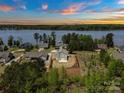 Picturesque waterfront home overlooking a calm lake surrounded by mature trees and lush landscapes at 10270 Lakeshore Dr, Lancaster, SC 29720