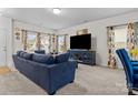 Bright living room featuring a large sofa, modern decor, and ample natural light at 111 Buoy Ln # 392, Statesville, NC 28677
