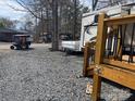 RV exterior with golf cart in RV community with gravel at 120 Cherokee Trl, Mount Gilead, NC 27306