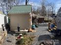 View of cottage, shed, and RV community with gravel at 120 Cherokee Trl, Mount Gilead, NC 27306