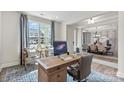 Sun-drenched office space with desk, chairs, decorative rug and an open view into the dining room at 13408 Chopin Ridge Rd, Huntersville, NC 28078