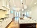 Contemporary kitchen with stainless steel appliances, granite counters, and hardwood floors at 178 Fulworth Nw Dr # 64, Concord, NC 28027