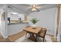 Cozy dining area features modern lighting and a wooden table adjacent to the kitchen at 1832 J Julian Ln # D, Charlotte, NC 28208