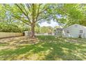 Large backyard with mature trees, new fence, and shed. Ideal for outdoor activities at 1905 Wood St, Gastonia, NC 28052