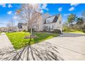 Well-maintained home featuring a long driveway, a two-car garage, and verdant landscaping at 2146 Holden Sw Ave, Concord, NC 28025