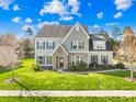 Beautiful two-story home featuring well-maintained landscaping, a stone facade, and a welcoming entrance at 2146 Holden Sw Ave, Concord, NC 28025